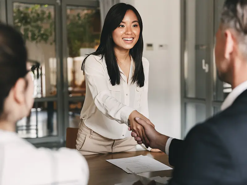 woman shaking a mans hand