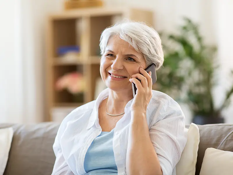 smiling older woman talking on phone