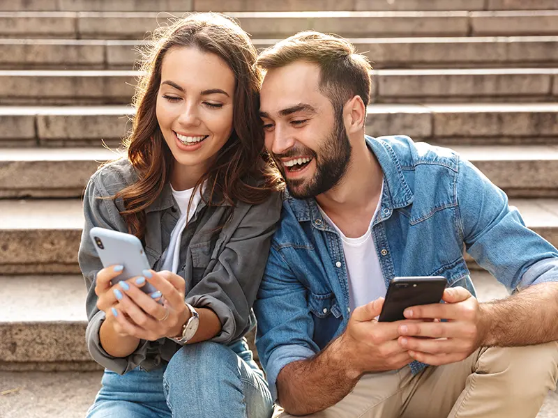 young guy and girl looking at phone